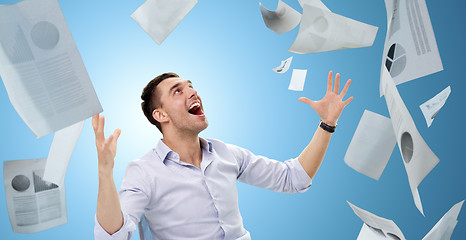 Image showing businessman with falling papers