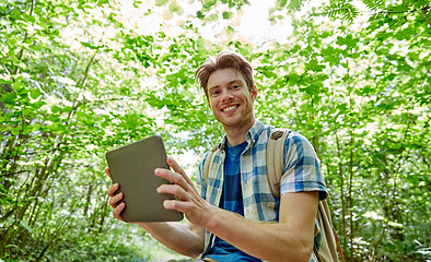 Image showing happy man with backpack and tablet pc in woods