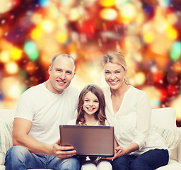 Image showing smiling family with laptop