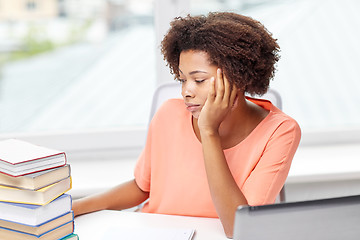 Image showing bored african american woman doing homework home