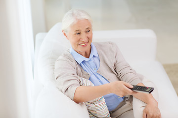 Image showing happy senior woman watching tv at home