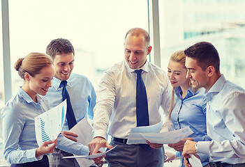 Image showing business people with papers talking in office