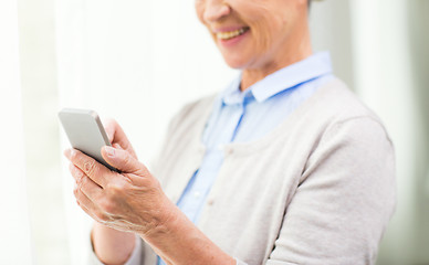 Image showing close up of senior woman with smartphone texting