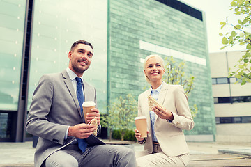 Image showing smiling businessmen with paper cups outdoors