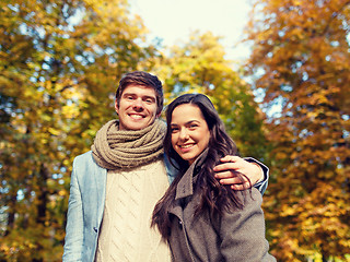 Image showing smiling couple hugging in autumn park