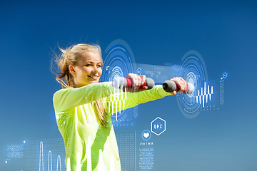 Image showing sporty woman with light dumbbells outdoors