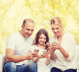 Image showing happy family with smartphones