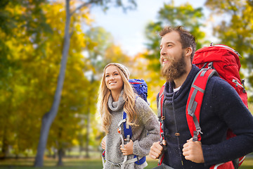 Image showing smiling couple with backpacks hiking