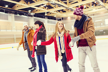 Image showing happy friends on skating rink