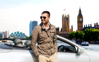 Image showing happy man near cabriolet car over london city