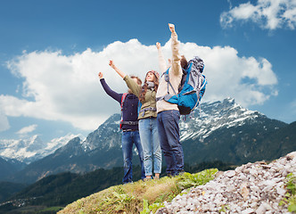 Image showing group of smiling friends with backpacks hiking