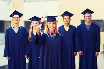 Image showing group of smiling students in mortarboards