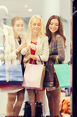 Image showing happy young women with shopping bags in mall