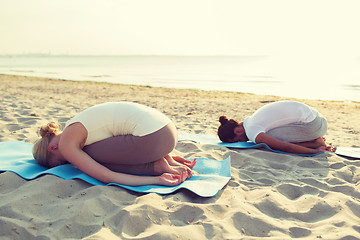 Image showing couple making yoga exercises outdoors