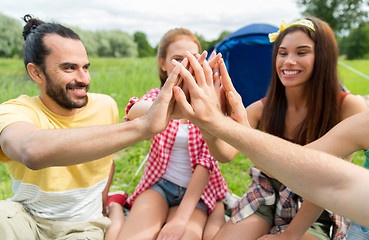 Image showing happy friends making high five at camping
