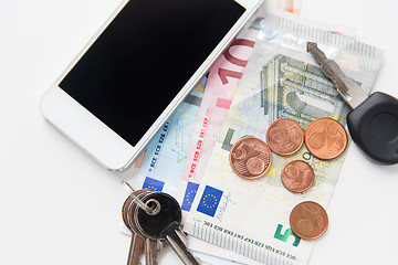 Image showing close up of smartphone, money and keys on table