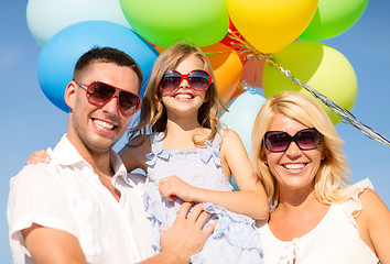 Image showing happy family with colorful balloons outdoors