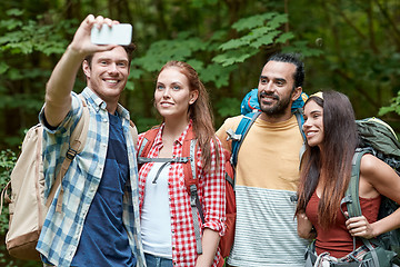 Image showing friends with backpack taking selfie by smartphone