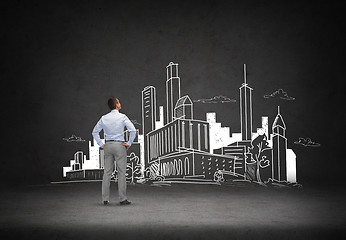 Image showing businessman looking at city drawing