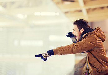 Image showing young man supporting hockey game on skating rink