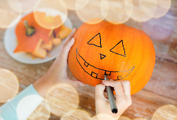 Image showing close up of woman with pumpkins at home