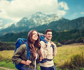 Image showing smiling couple with backpacks hiking