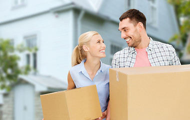 Image showing couple with cardboard boxes moving to new home