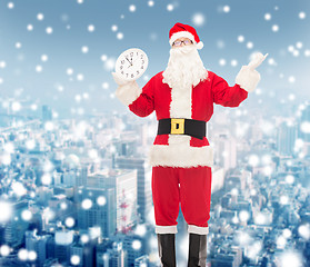 Image showing man in costume of santa claus with clock