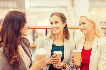 Image showing young women with shopping bags and coffee in mall