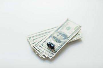 Image showing close up of black dice and dollar cash money