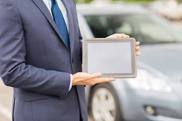 Image showing close up of young man with tablet pc and car