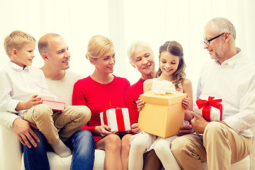 Image showing smiling family with gifts at home