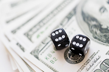 Image showing close up of black dice and dollar cash money