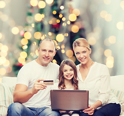 Image showing happy family with laptop computer and credit card