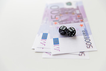 Image showing close up of black dice and euro cash money