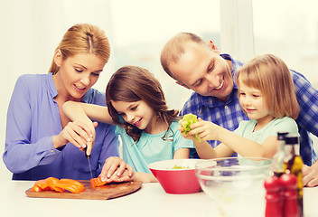 Image showing happy family with two kids making dinner at home