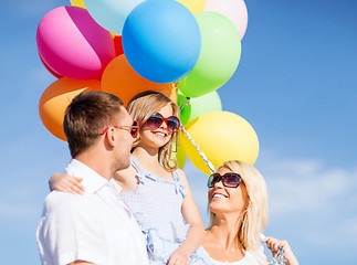 Image showing family with colorful balloons