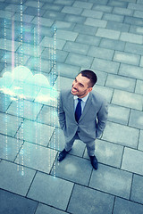 Image showing young smiling businessman outdoors from top