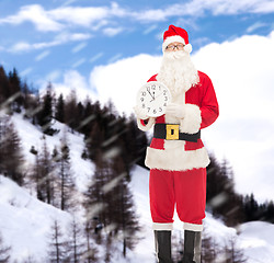 Image showing man in costume of santa claus with clock