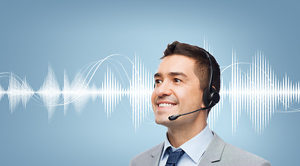 Image showing businessman in headset over sound wave or diagram