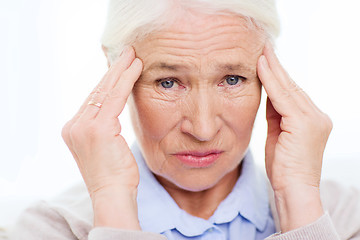 Image showing face of senior woman suffering from headache