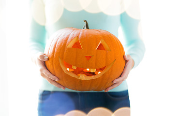 Image showing close up of woman with pumpkins at home