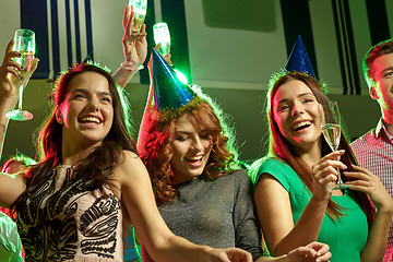 Image showing smiling friends with glasses of champagne in club