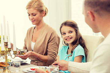 Image showing smiling family having holiday dinner at home