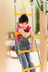 Image showing happy little girl climbing on children playground