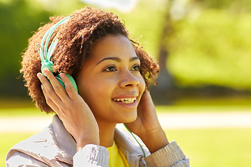 Image showing african woman in headphones listening to music