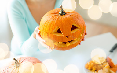 Image showing close up of woman with pumpkins at home