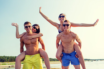 Image showing smiling friends having fun on summer beach