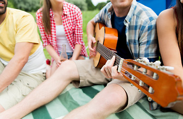 Image showing happy friends with drinks and guitar at camping