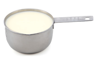 Image showing Milk in a measuring cup